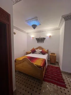 a bedroom with a bed and a blue ceiling at Dar Moulin in Fès