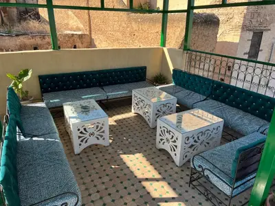 a group of benches and tables on a patio at Dar Moulin in Fès