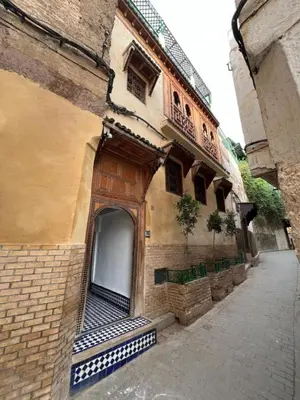 an old building with a door on the side of it at Dar Moulin in Fès