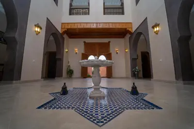 a lobby with a fountain in the middle of a room at Palais Menzah & SPA in Marrakech