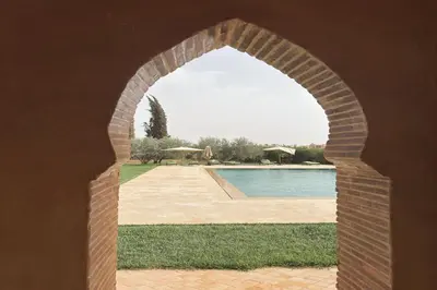 an archway with a pool in the background at Palais Menzah & SPA in Marrakech