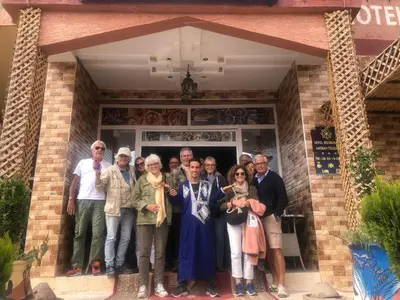 a group of people standing in front of a building at Hotel kasbah telouet in Telouet