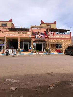 a building with a car parked in front of it at Hotel kasbah telouet in Telouet