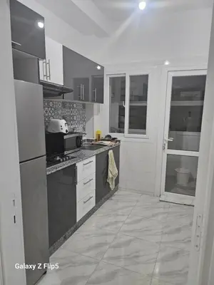 a kitchen with a sink and a stove at Appartement bassatine in Fès
