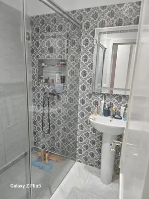 a bathroom with a sink and a shower at Appartement bassatine in Fès