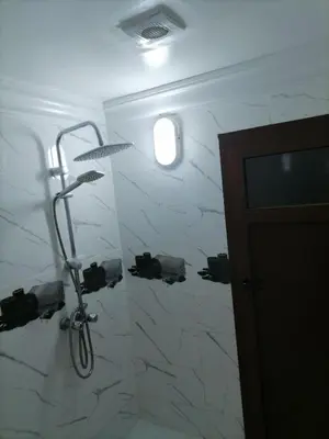 a bike hanging on a wall in a bathroom at Big flat in ouarzazate city, Morocco in Ouarzazate