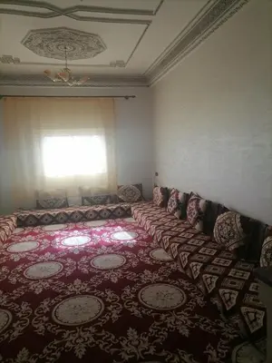 an empty room with a couch and a window at Big flat in ouarzazate city, Morocco in Ouarzazate
