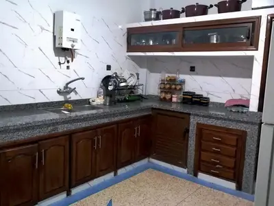 a kitchen with a sink and wooden cabinets at Big flat in ouarzazate city, Morocco in Ouarzazate