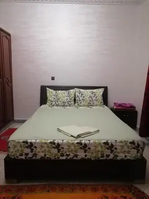 a bedroom with a bed with a white bedspread at Big flat in ouarzazate city, Morocco in Ouarzazate