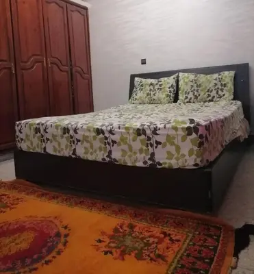 a bed in a room with a bedskirtspectspectspects at Big flat in ouarzazate city, Morocco in Ouarzazate