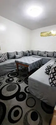a living room with couches and a rug at Apparemment bien équipé in Beni Mellal