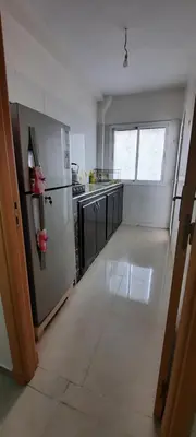 a kitchen with a stainless steel refrigerator in a room at Apparemment bien équipé in Beni Mellal