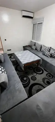 a living room with couches and a coffee table at Apparemment bien équipé in Beni Mellal