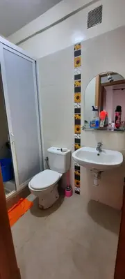 a bathroom with a toilet and a sink at Apparemment bien équipé in Beni Mellal