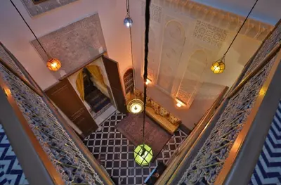 an overhead view of a staircase with a chandelier at Dar Fes Flower in Fès