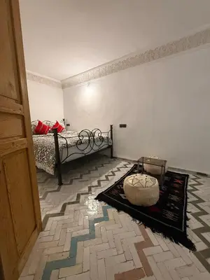 a room with a bed and a rug on the floor at Dar Fes Flower in Fès