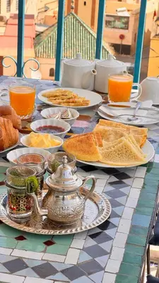 a table topped with plates of food on a table at Dar Fes Flower in Fès