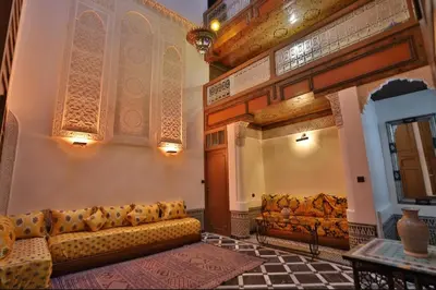 a living room with a couch and a table at Dar Fes Flower in Fès