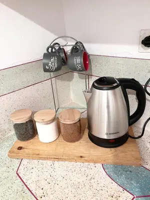 a tea kettle and three containers on a wooden tray at Ferme d'hôtes Pouvoir des Plantes in Ourika