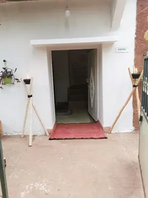 a door into a room with a red rug at Ferme d'hôtes Pouvoir des Plantes in Ourika