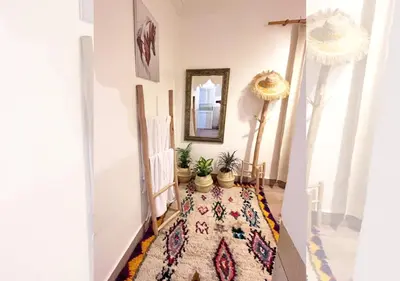 a hallway with potted plants and a rug at Ferme d'hôtes Pouvoir des Plantes in Ourika