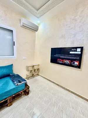 a living room with a flat screen tv on the wall at Menzeh saiss appartement in Fès