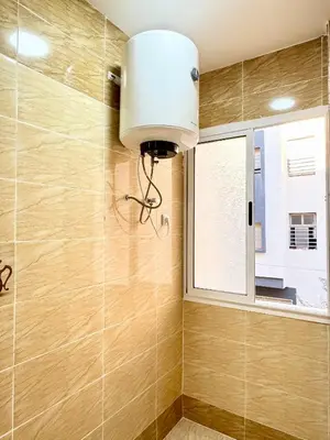 a light fixture in a bathroom with a window at Menzeh saiss appartement in Fès