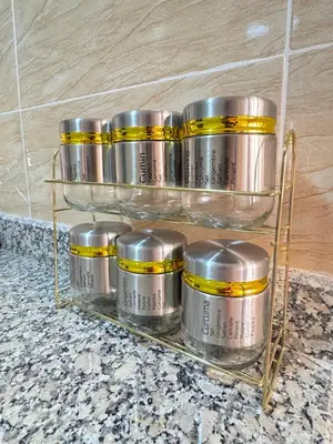 a group of silver containers on a rack on a counter at Menzeh saiss appartement in Fès