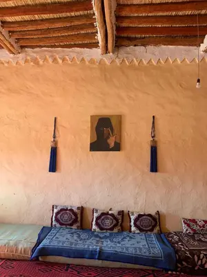 a room with a couch and a picture of a person at Hammadi Camp in Mhamid