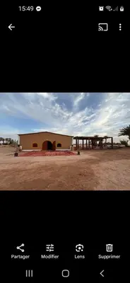 a picture of a building in the middle of a field at Hammadi Camp in Mhamid