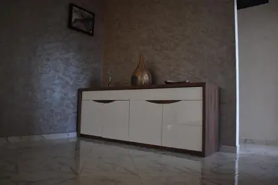 a white cabinet in a room with a vase on top at Bloemenhuis 2 - Centre-ville Fez in Fès