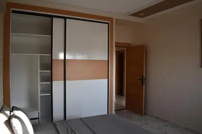 a bedroom with a glass closet and a bed at Bloemenhuis 2 - Centre-ville Fez in Fès