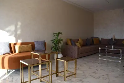 a living room with a couch and two tables at Bloemenhuis 2 - Centre-ville Fez in Fès