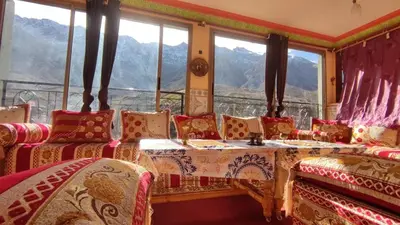a room with a couch and a table and windows at Dar agzwal in Tacheddirt