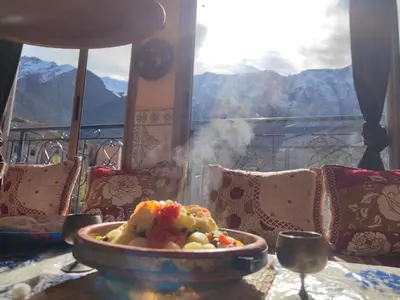 a bowl of food on a table with a view of mountains at Dar agzwal in Tacheddirt