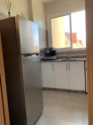 a kitchen with a stainless steel refrigerator and a window at Lolla home in Ifrane