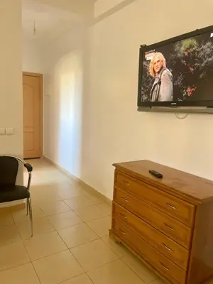 a living room with a flat screen tv on the wall at Lolla home in Ifrane