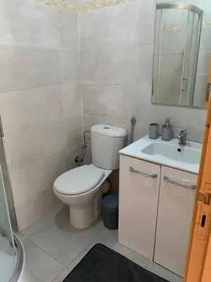 a bathroom with a toilet and a sink and a mirror at Lolla home in Ifrane