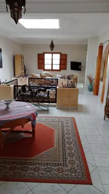 a living room with a couch and a rug at John's Place in Chrabli