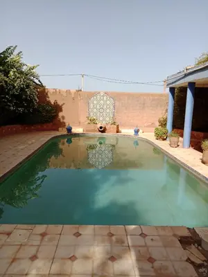 a small swimming pool in a yard at John's Place in Chrabli
