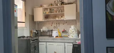 a kitchen with white cabinets and a counter top at Guercif in Guercif