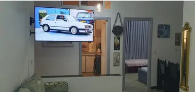 a tv in a living room with a white car on the screen at Guercif in Guercif