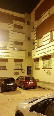 two cars parked in a parking lot in front of a building at Guercif in Guercif