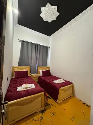 two beds in a room with a star on the ceiling at Moorish Cabana in Fès
