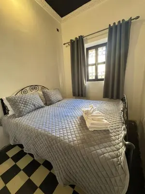 a bedroom with a bed with towels on it at Moorish Cabana in Fès