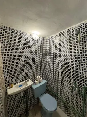 a bathroom with a blue toilet and a sink at Moorish Cabana in Fès