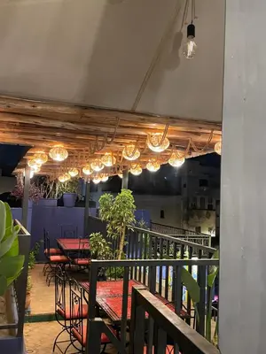 a patio with a table and chairs and lights at Moorish Cabana in Fès