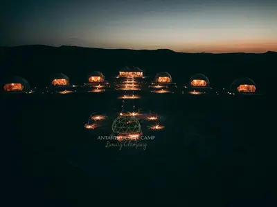 a group of lights in a field at night at Antares Desert Camp in Merzouga