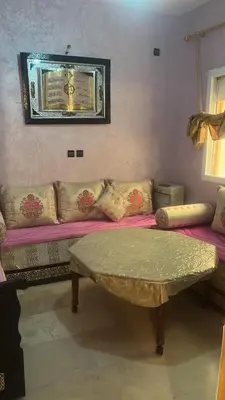 a living room with a couch and a table at Très bel Apt Fès,3 ch dans un quartier trop chic bien placé in Fès
