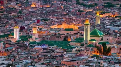 a view of a city at night with mosques at Très bel Apt Fès,3 ch dans un quartier trop chic bien placé in Fès